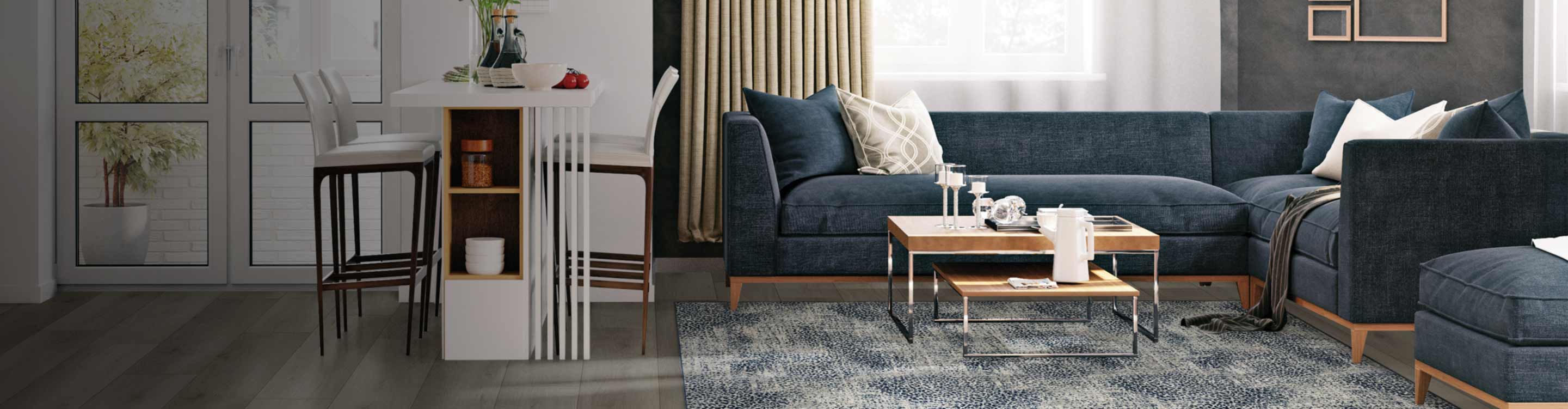 Open-concept interior with a white bar counter on the left and a cozy living room on the right, featuring a speckled blue and grey area rug, with a dark blue sectional sofa, and nesting coffee tables.